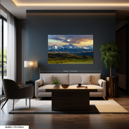 a modern living room with a large wall-mounted painting of a mountain landscape. The painting features a stunning view of snow-capped mountains under a vibrant sky. The room is furnished with a white sofa, a coffee table, and a potted plant, creating a cozy and inviting atmosphere.