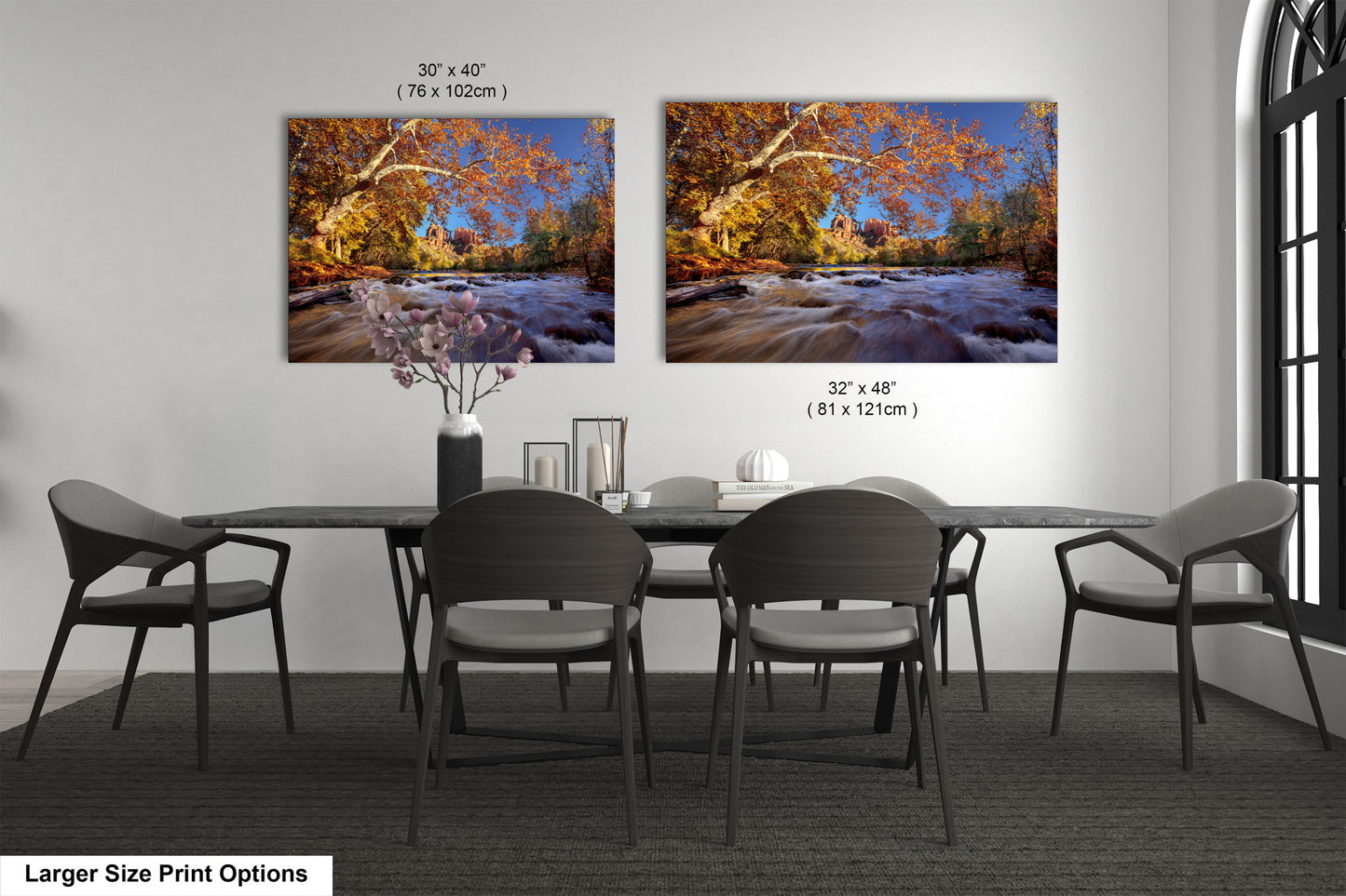 a dining room table with four chairs and two pictures on the wall