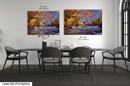 a dining room table with four chairs and two pictures on the wall