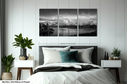 a black and white photo of a bed with a mountain range in the background