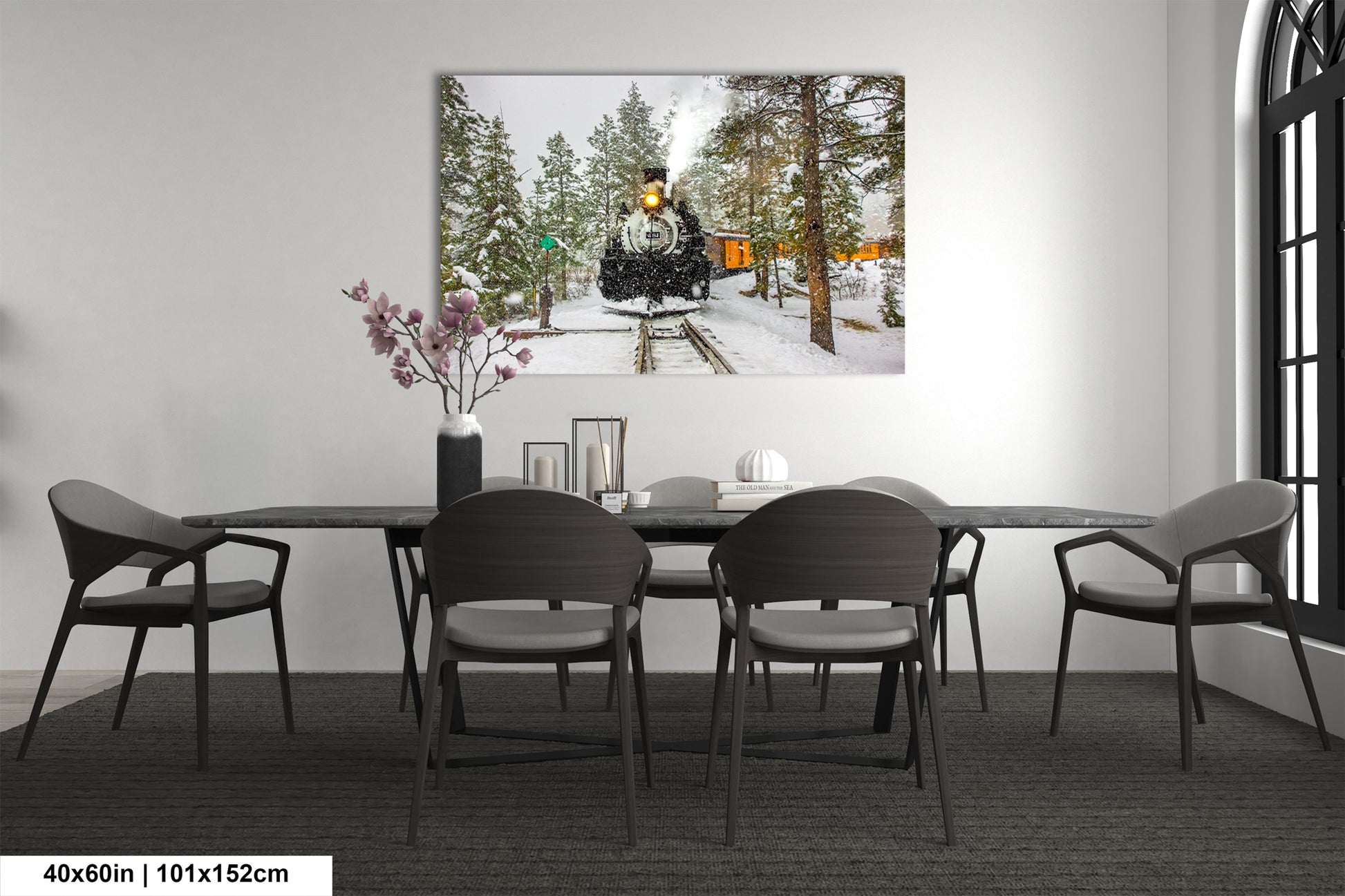a dining room table with chairs and a painting on the wall
