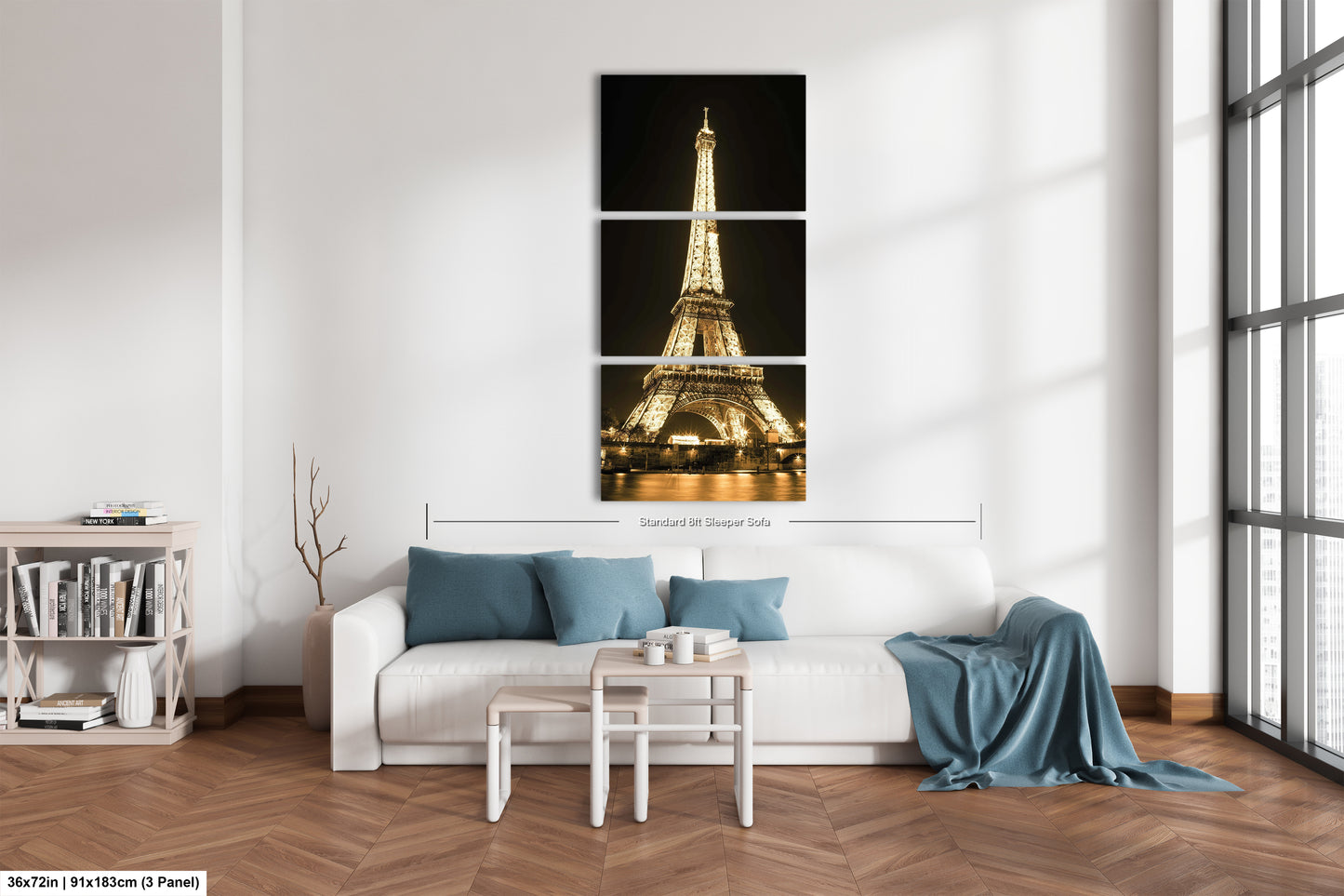 a living room with a white couch and a picture of the eiffel tower
