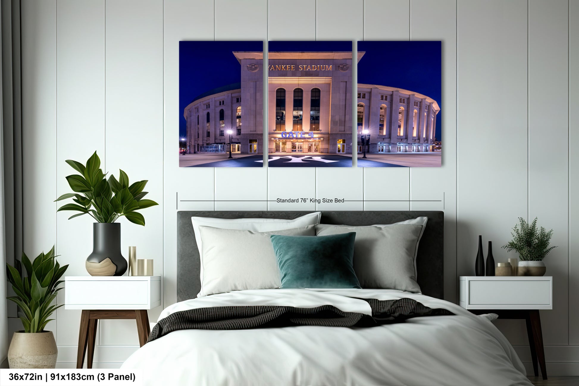 A bedroom with a large wall-mounted print of the Yankee Stadium at night, featuring the stadium's exterior and surrounding area.