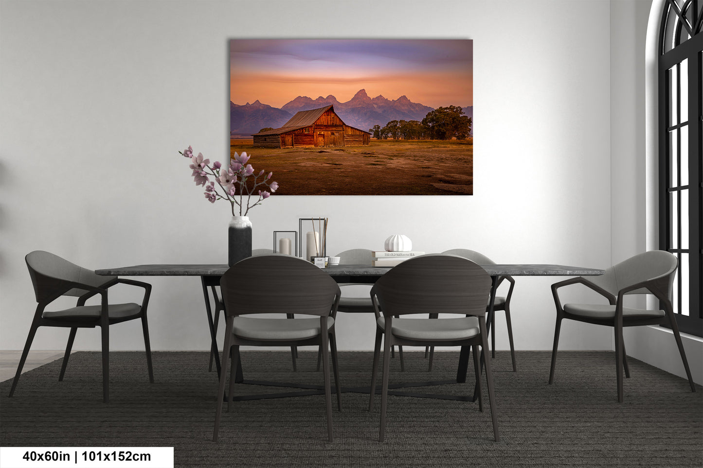 a dining room table with chairs and a painting on the wall