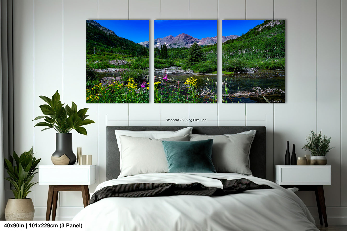a bed room with a neatly made bed and two pictures on the wall