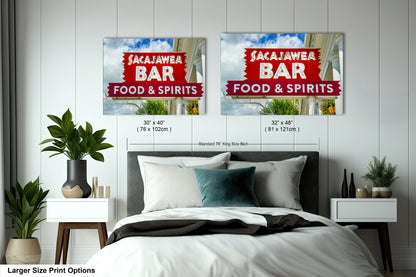 a bed room with a neatly made bed and two signs on the wall