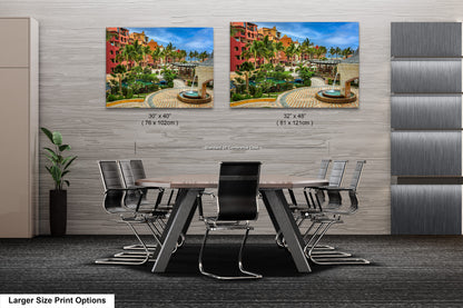 a dining room table with chairs and two pictures on the wall