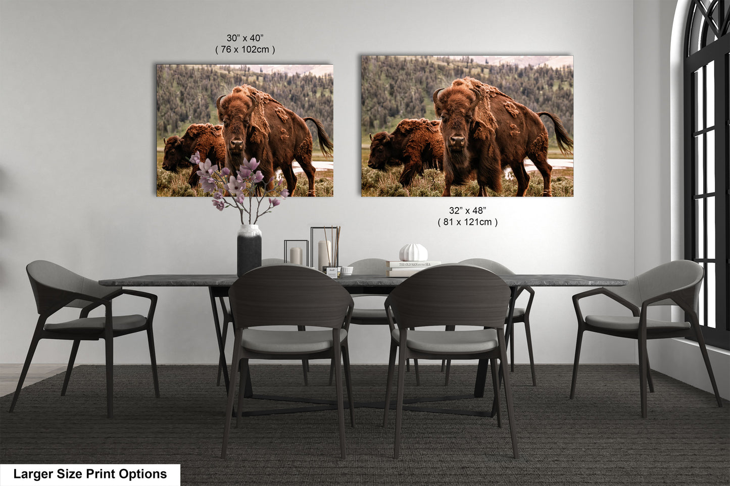 a dining room table with chairs and a picture of a bison on the wall
