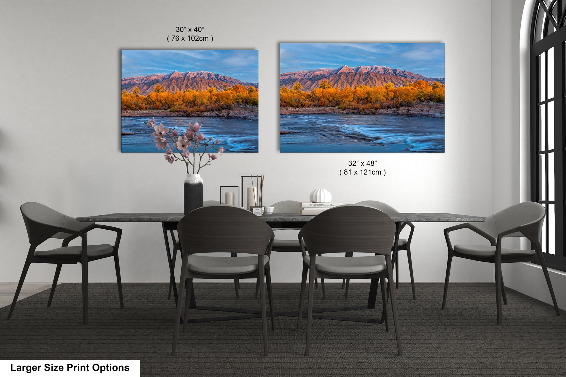 a dining room table with chairs and a painting on the wall