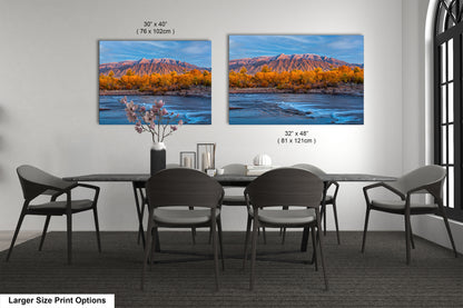 a dining room table with chairs and a painting on the wall