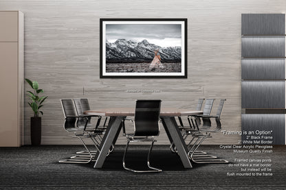 a dining room table with chairs and a picture hanging on the wall