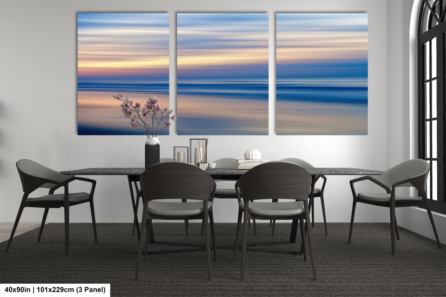 a dining room table with four chairs and a painting on the wall