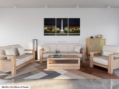 a living room filled with furniture and a painting on the wall