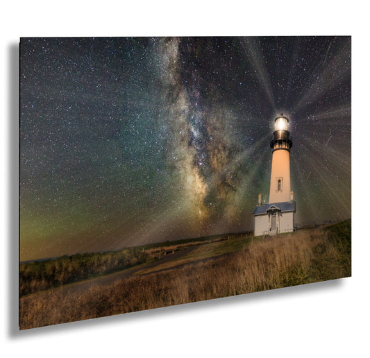 a lighthouse under a night sky filled with stars