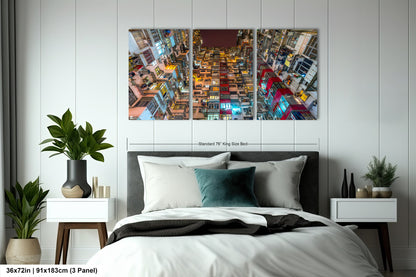 a bedroom with a bed and two paintings on the wall