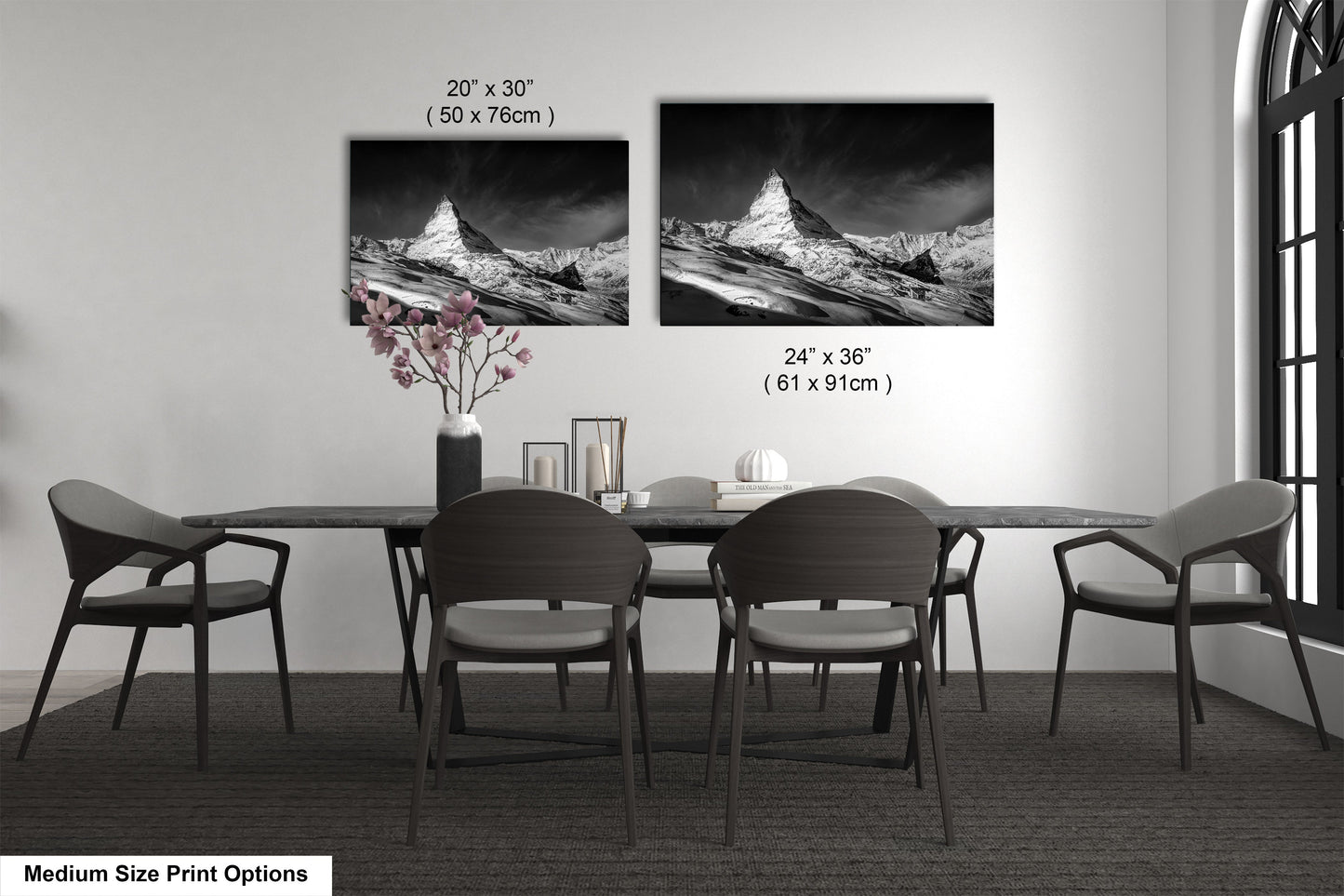 a dining table with four chairs and a vase of flowers