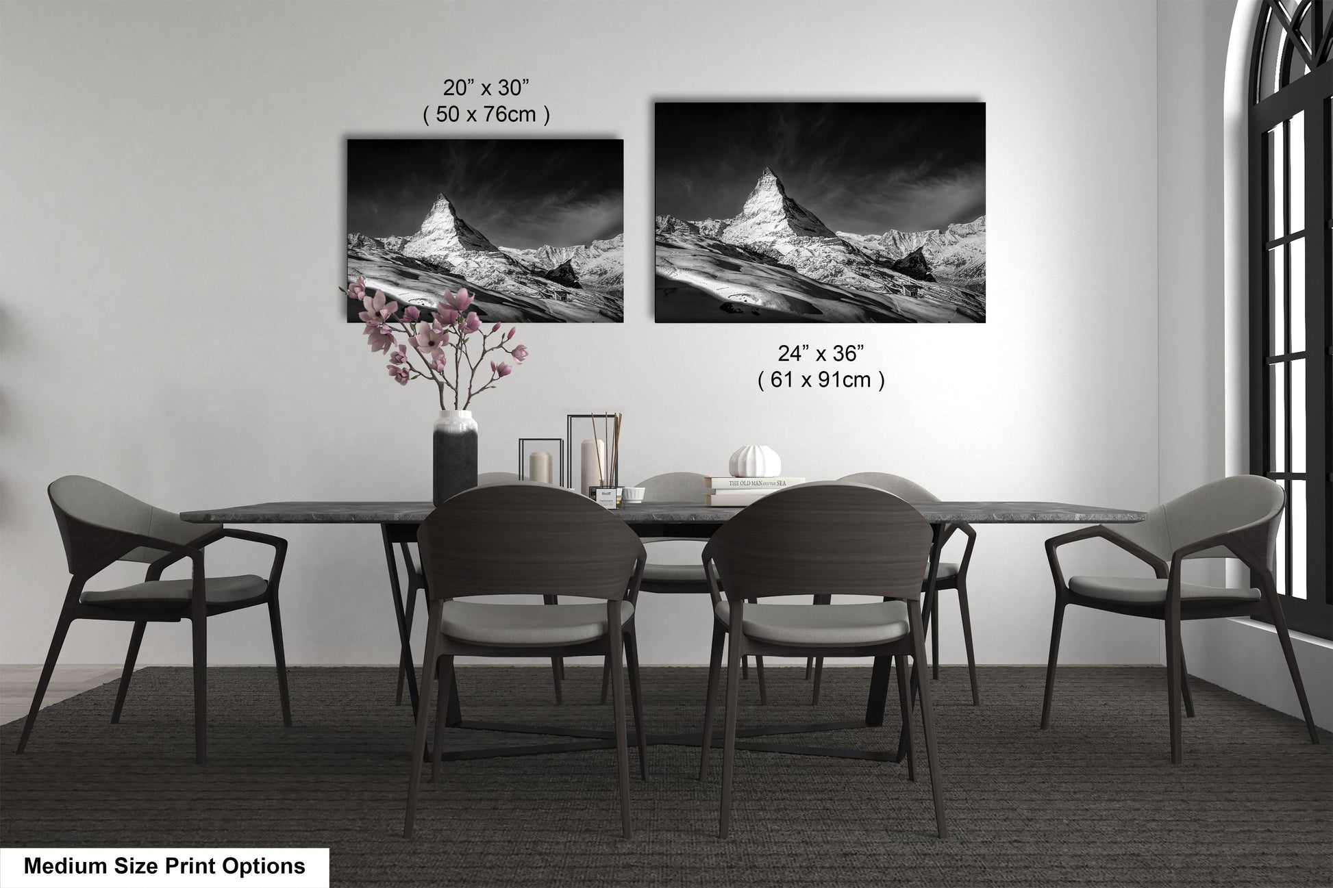 a dining table with four chairs and a vase of flowers