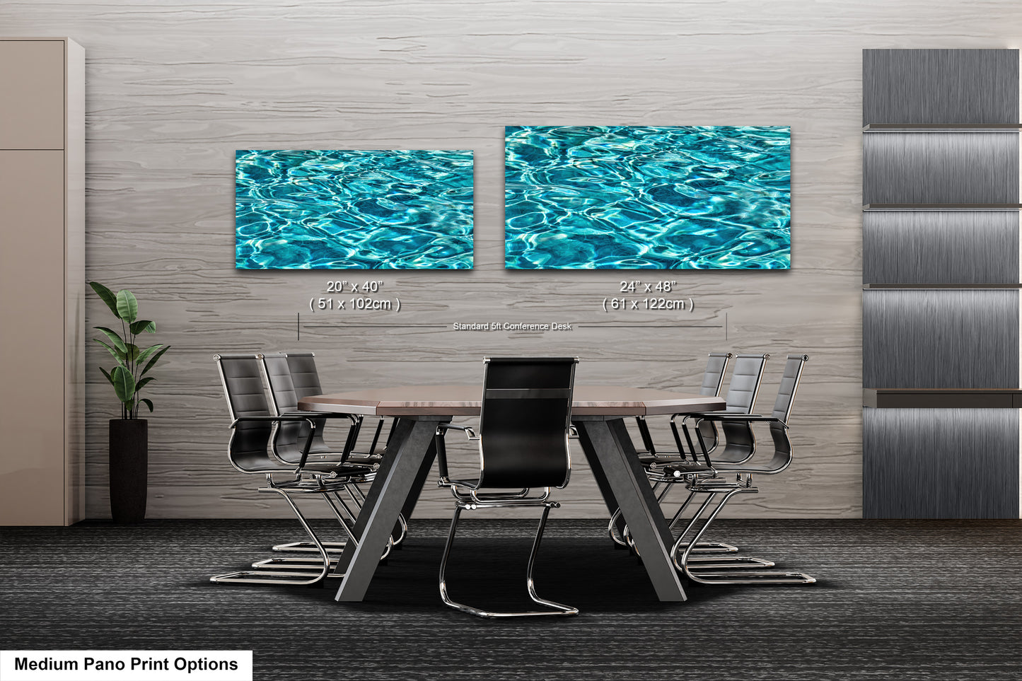 a modern office or conference room with a large wooden table surrounded by black chairs. Above the table, there are two framed prints of water, creating a serene and calming atmosphere. The prints are of different sizes, with one being larger than the other. The room has a neutral color scheme, with gray walls and a gray carpet.