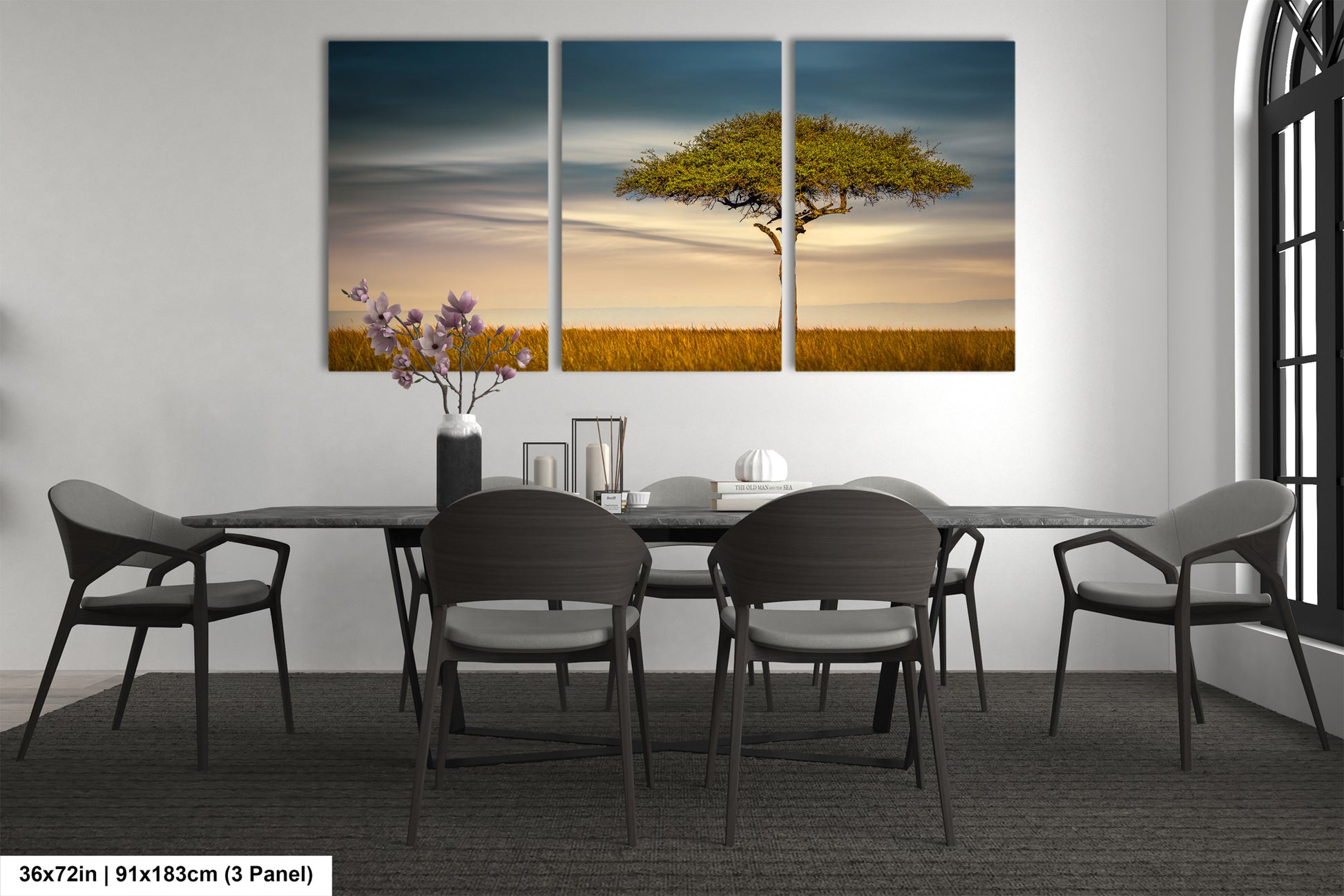 a dining room table with chairs and a painting on the wall