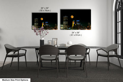 a dining room table with four chairs and a vase with flowers