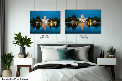 a bedroom with a large bed and two pictures on the wall
