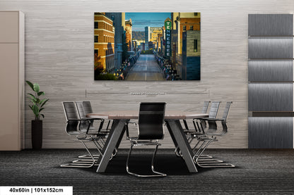 a dining room table with chairs and a painting on the wall