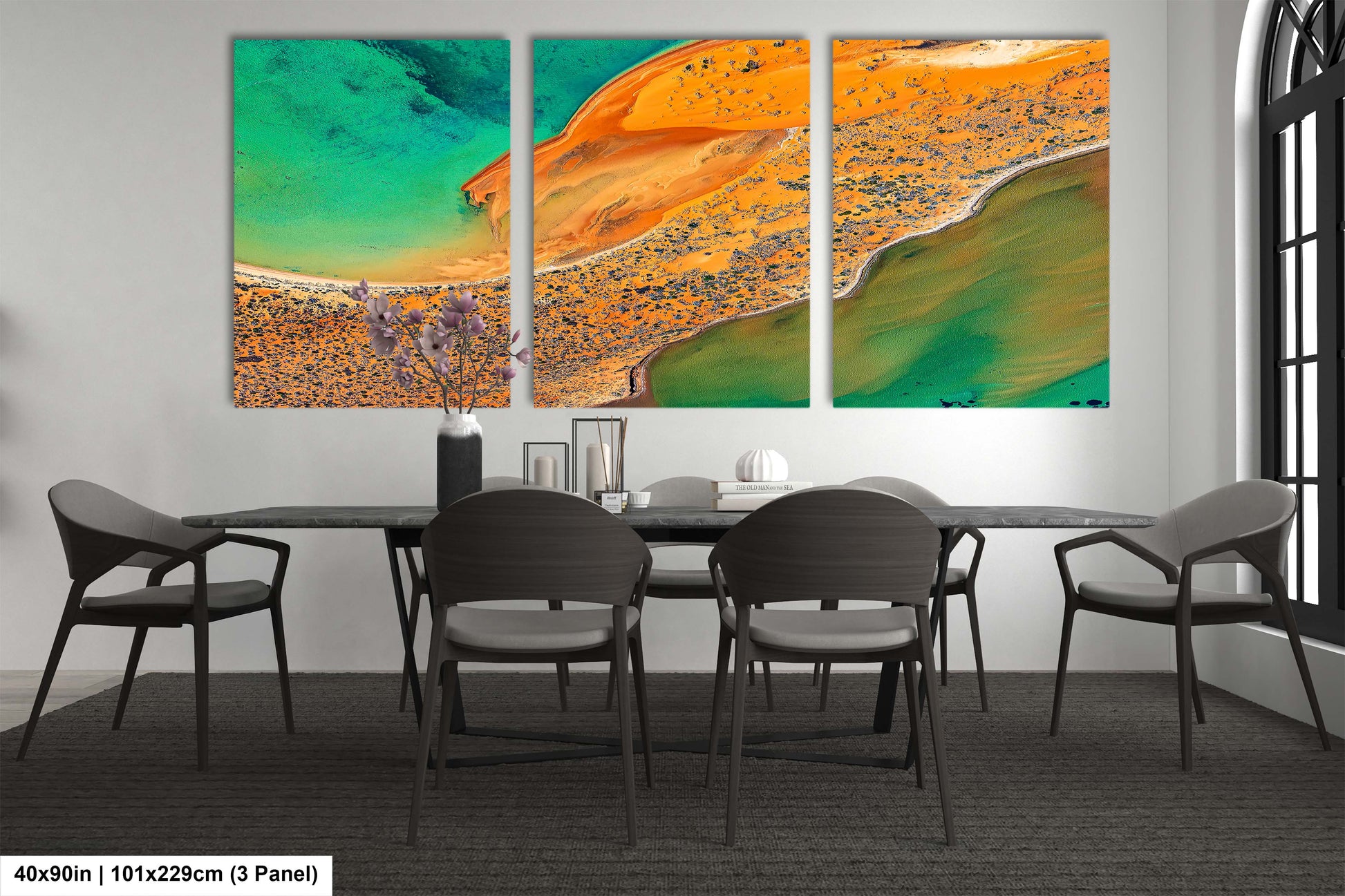 a dining room table with chairs and a painting on the wall