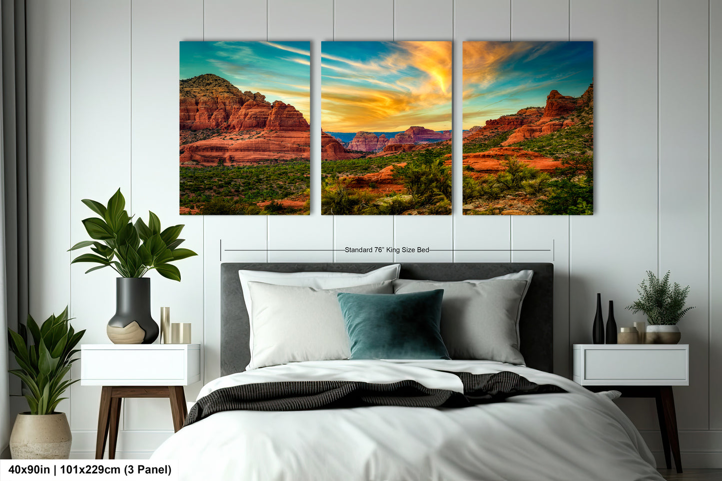 a bed room with a neatly made bed and two paintings on the wall