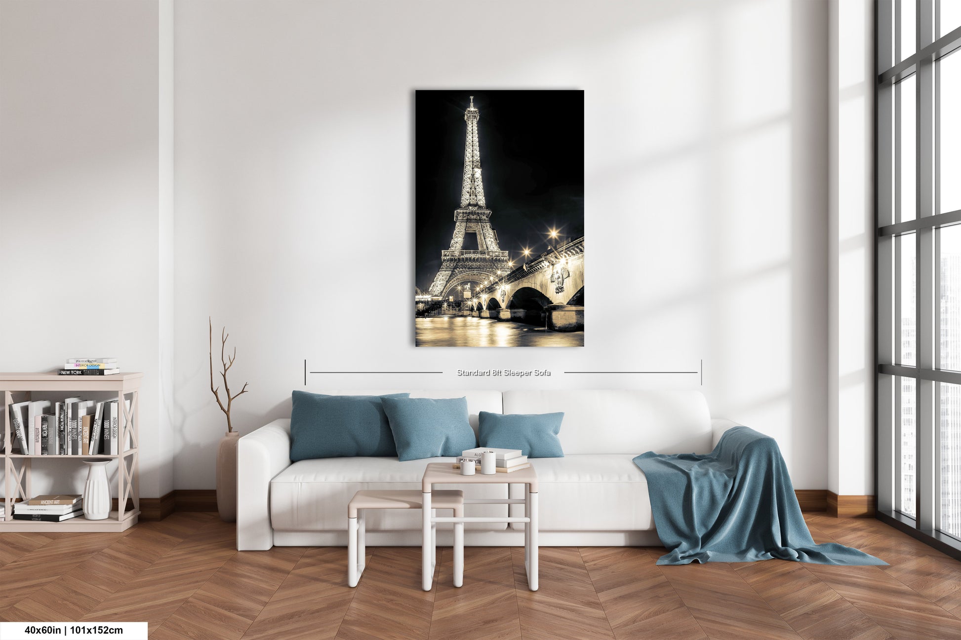 a living room with a white couch and a painting of the eiffel tower