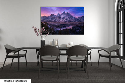 a dining room table with chairs and a painting on the wall