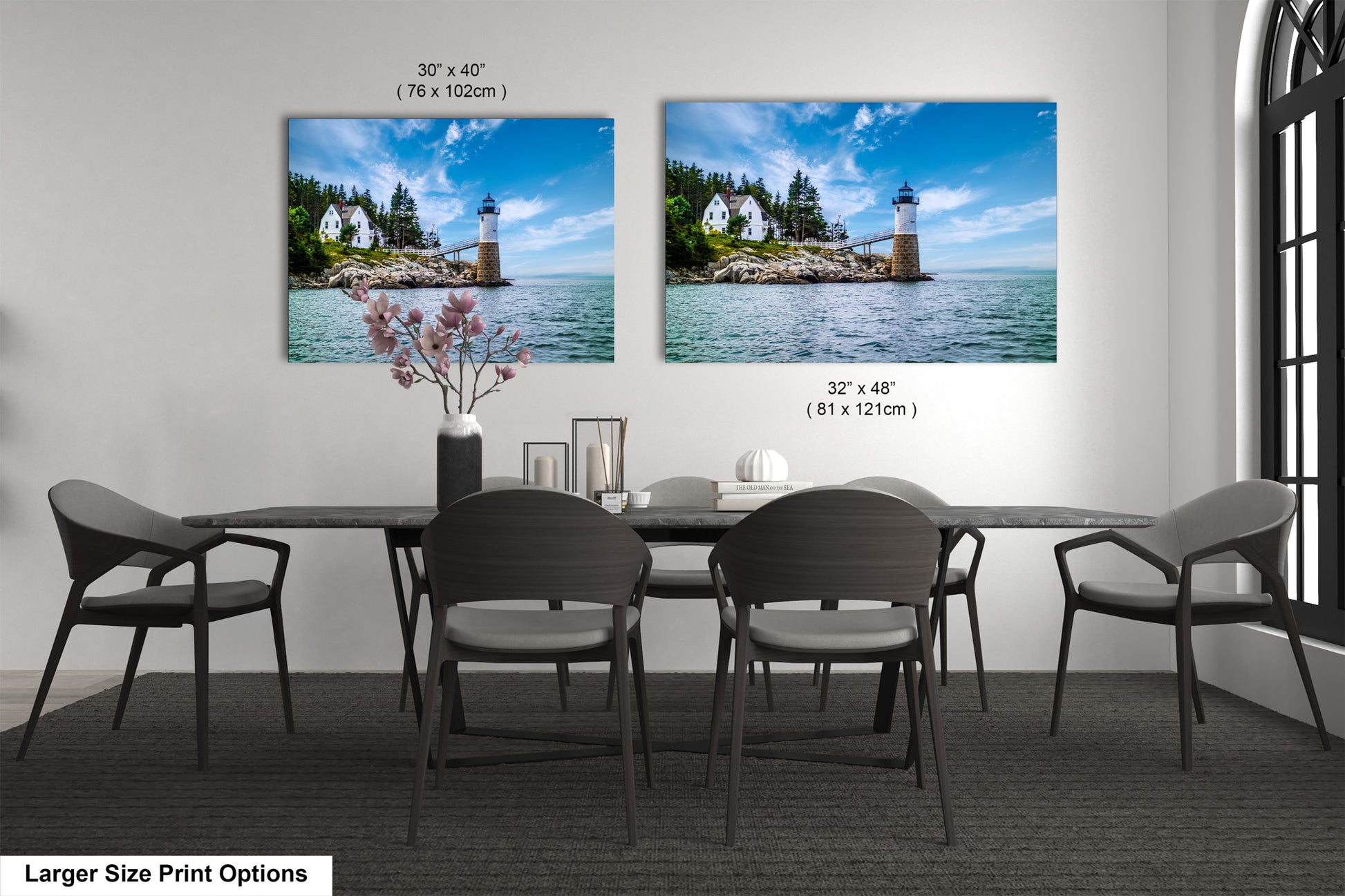 a dining room table with four chairs and two pictures on the wall