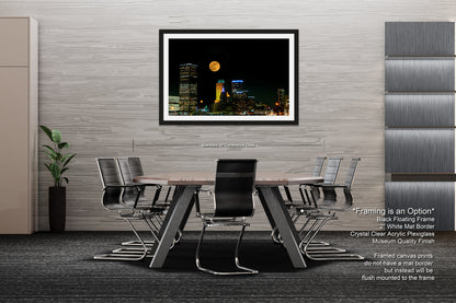 a picture of a city at night with a full moon