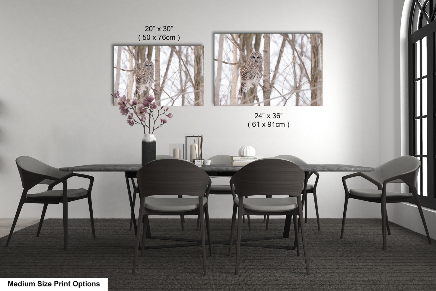 a dining room table with four chairs and a vase with flowers