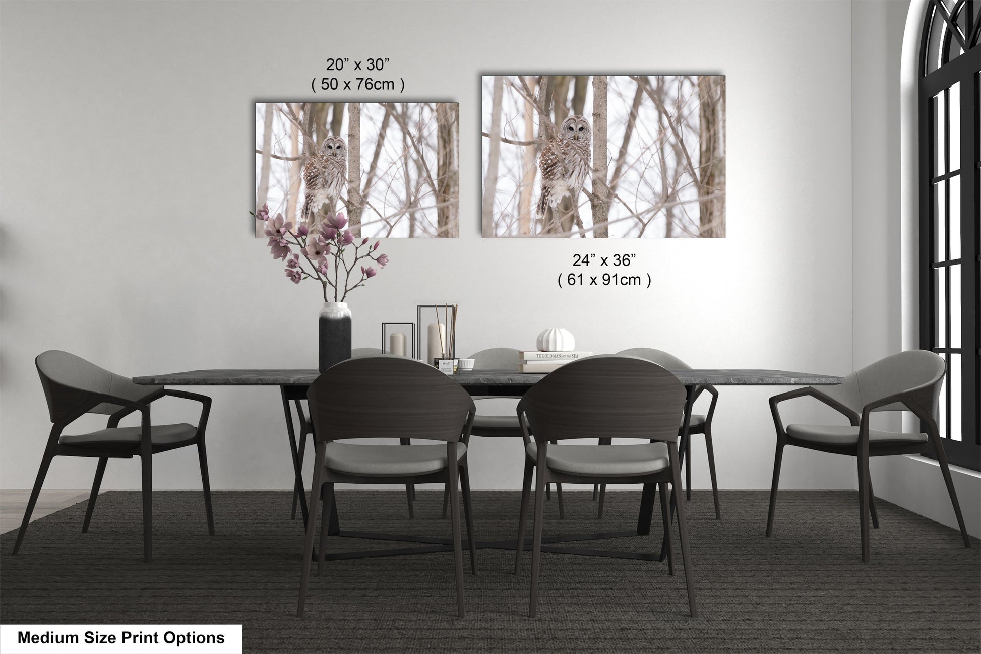 a dining room table with four chairs and a vase with flowers