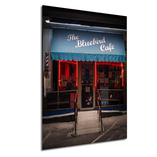 a store front with a blue awning and red lights