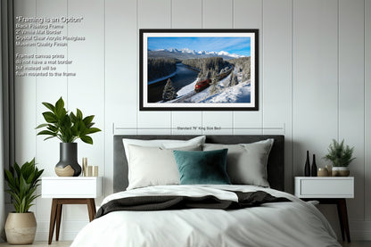 a bedroom with a large framed picture of a snowy mountain landscape hanging on the wall above a bed with white bedding.