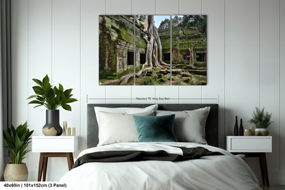 a bedroom with a bed and a large tree on the wall