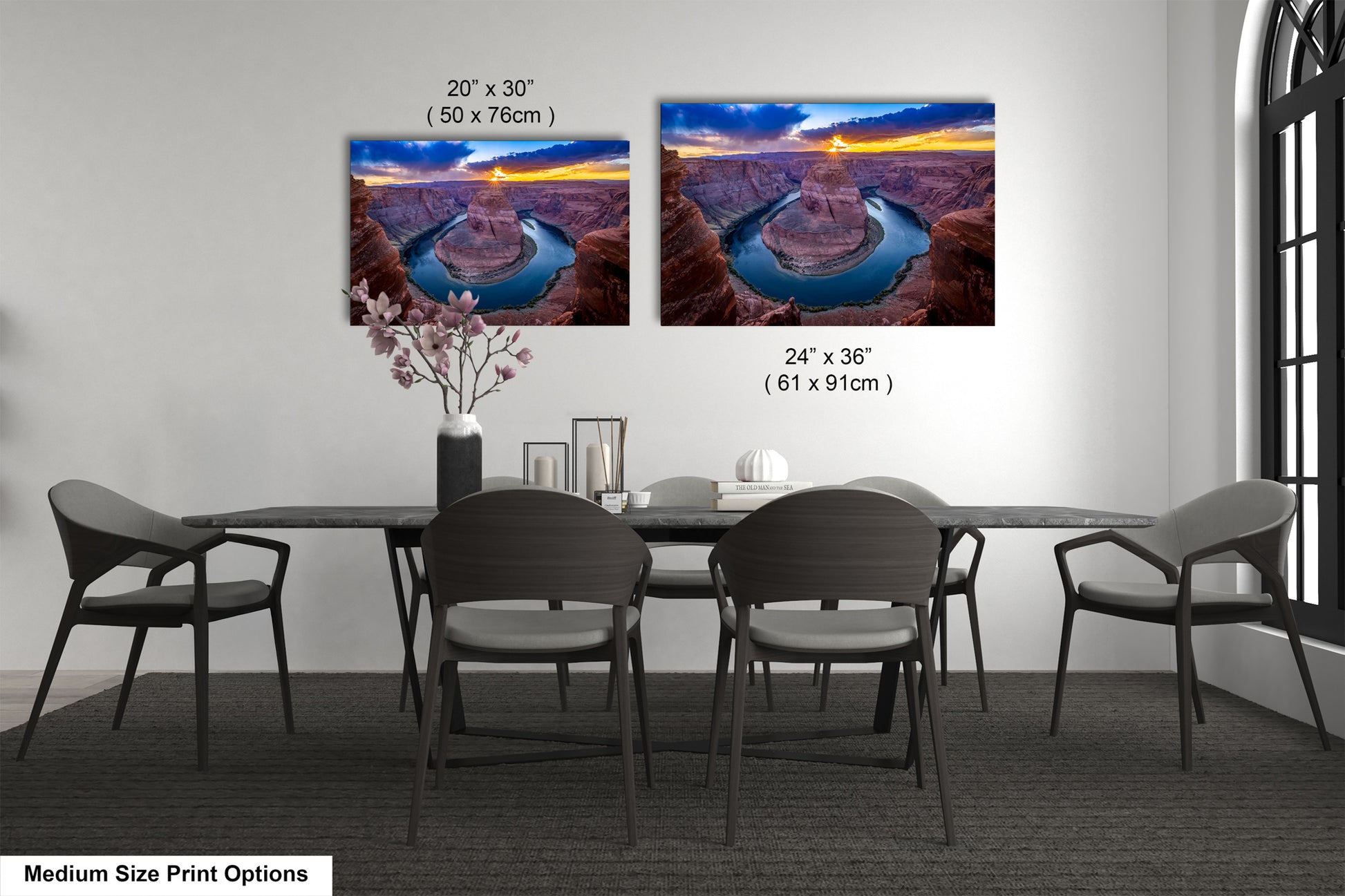 a dining room table with four chairs and two pictures on the wall