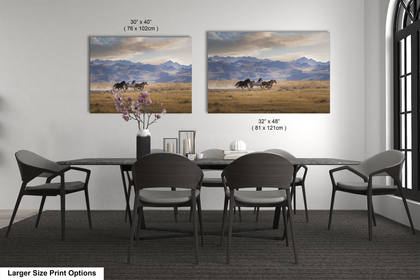 a dining room table with four chairs and two pictures on the wall