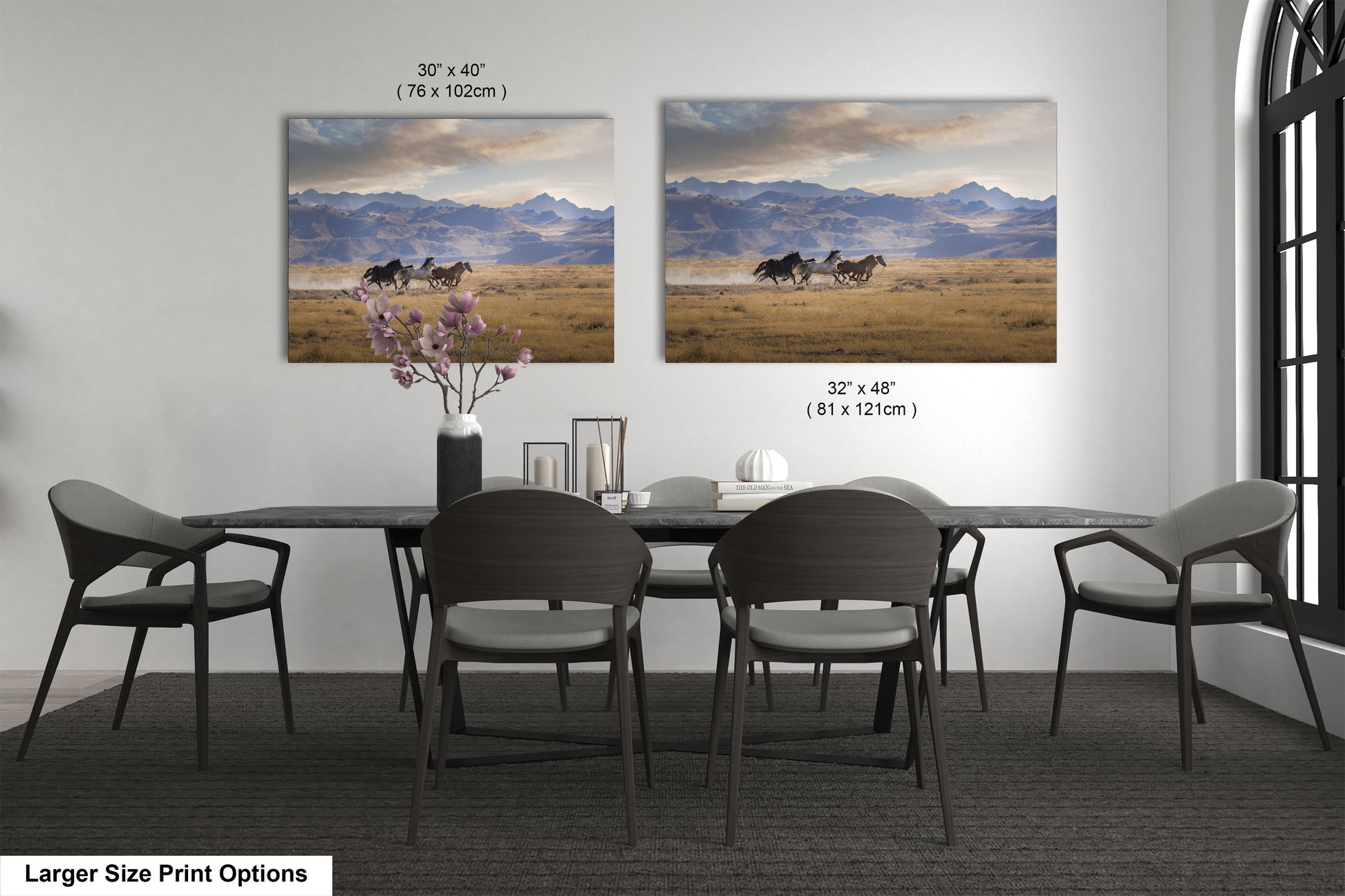 a dining room table with four chairs and two pictures on the wall