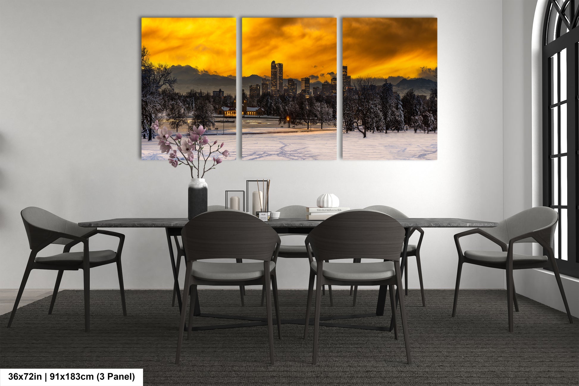 a dining room table with four chairs and a painting on the wall