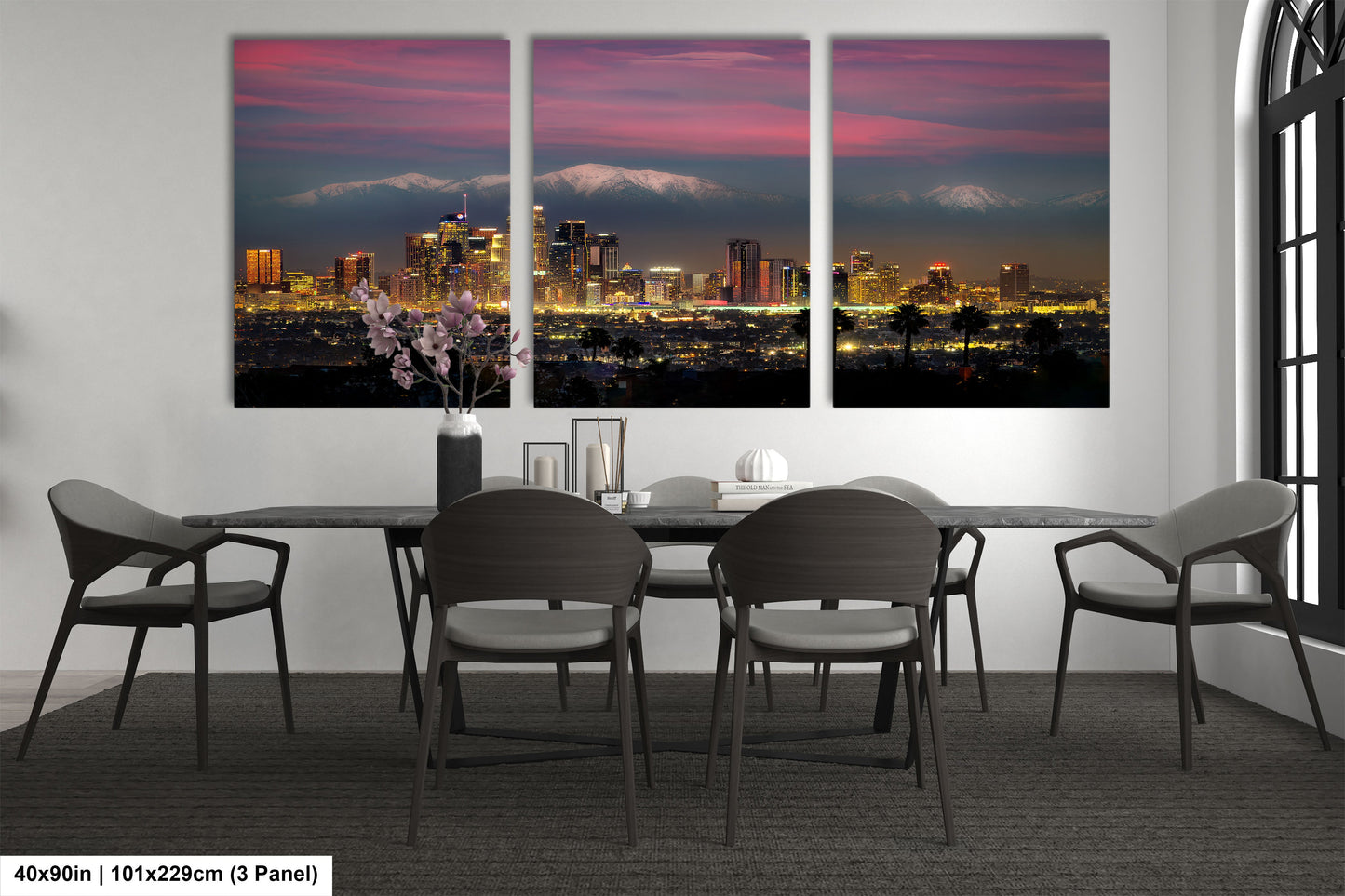 a dining room table with four chairs and a view of a city