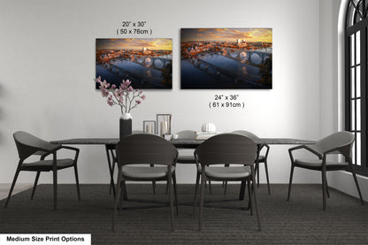 a dining table with four chairs and a vase of flowers