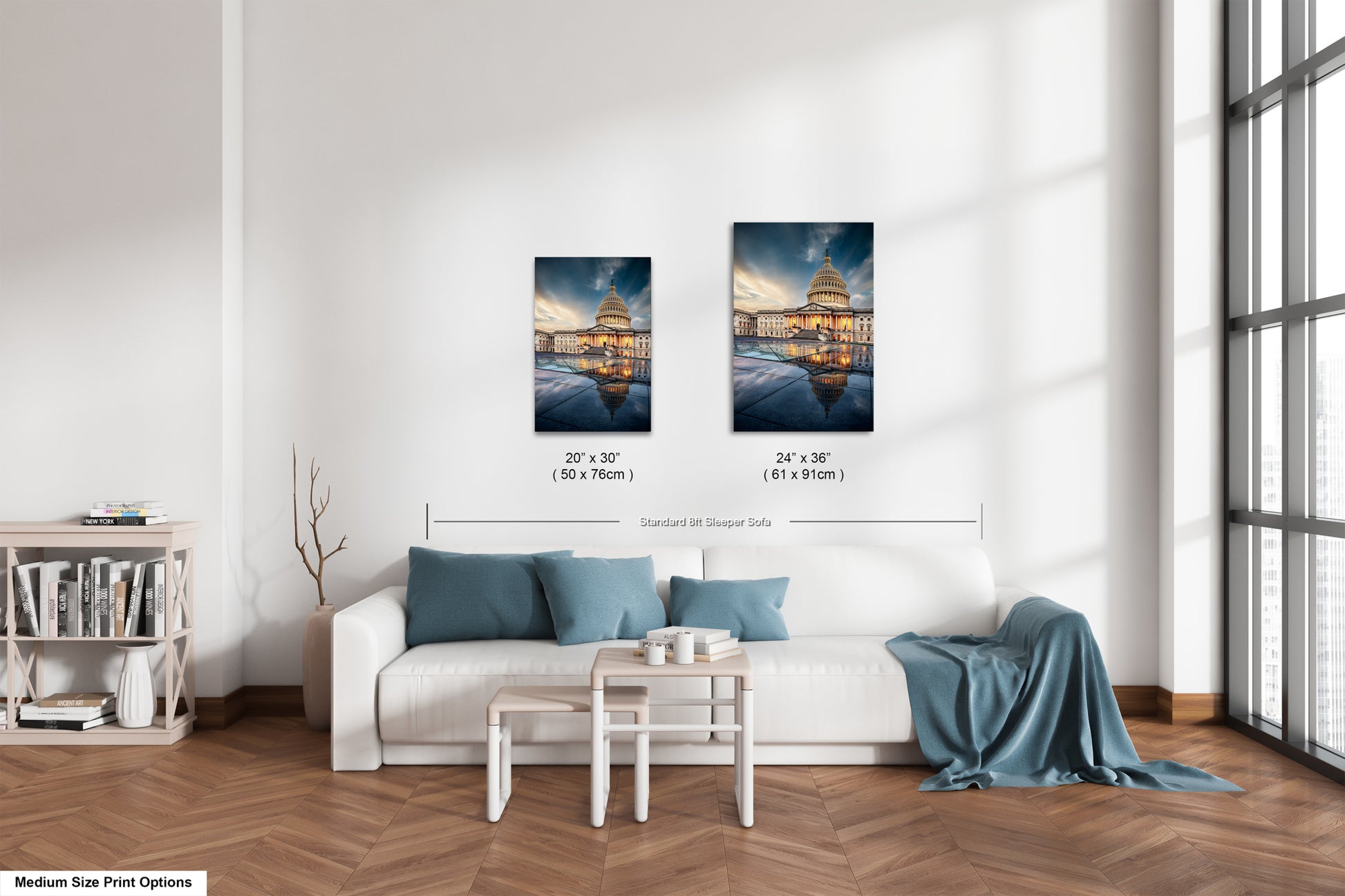 a living room with a white couch and two pictures on the wall