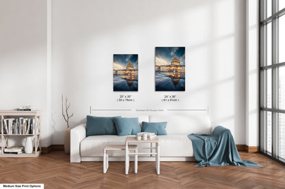 a living room with a white couch and two pictures on the wall