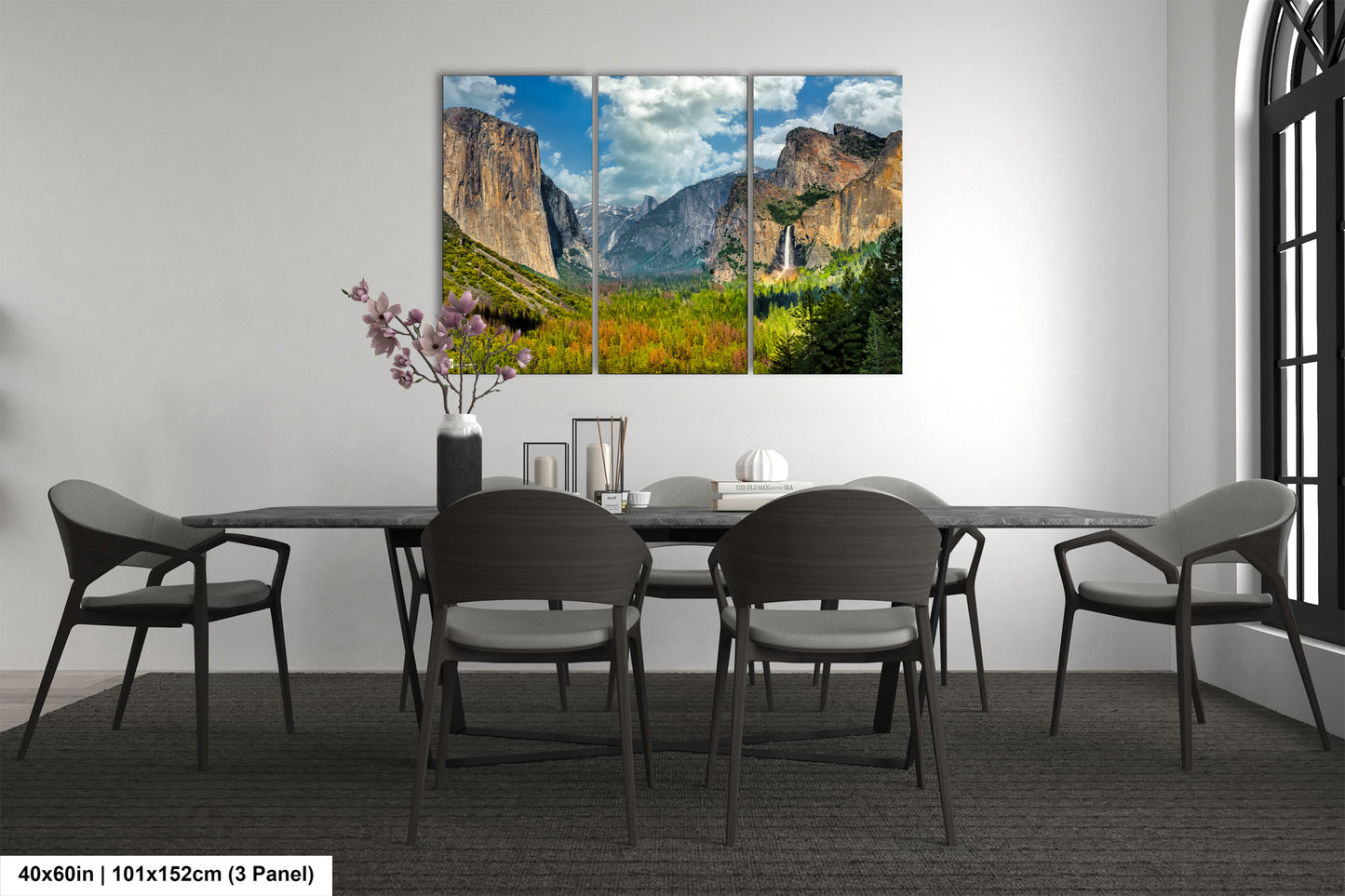 a dining room table with chairs and a painting on the wall