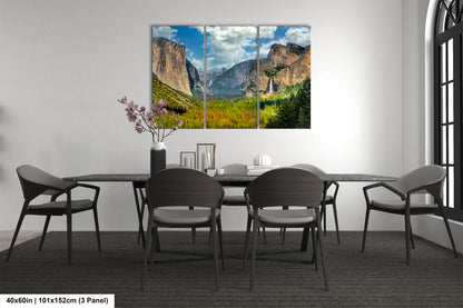 a dining room table with chairs and a painting on the wall