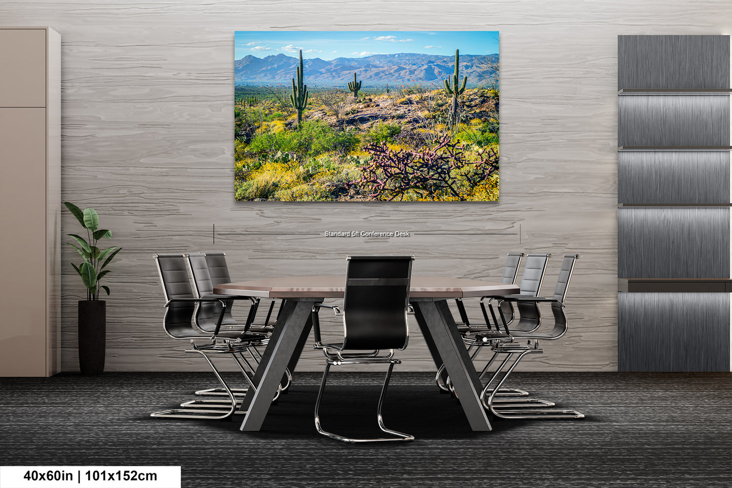 a modern office space with a large, colorful painting of a desert landscape hanging on the wall above a wooden table surrounded by chairs.