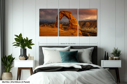a bed room with a neatly made bed and three pictures on the wall