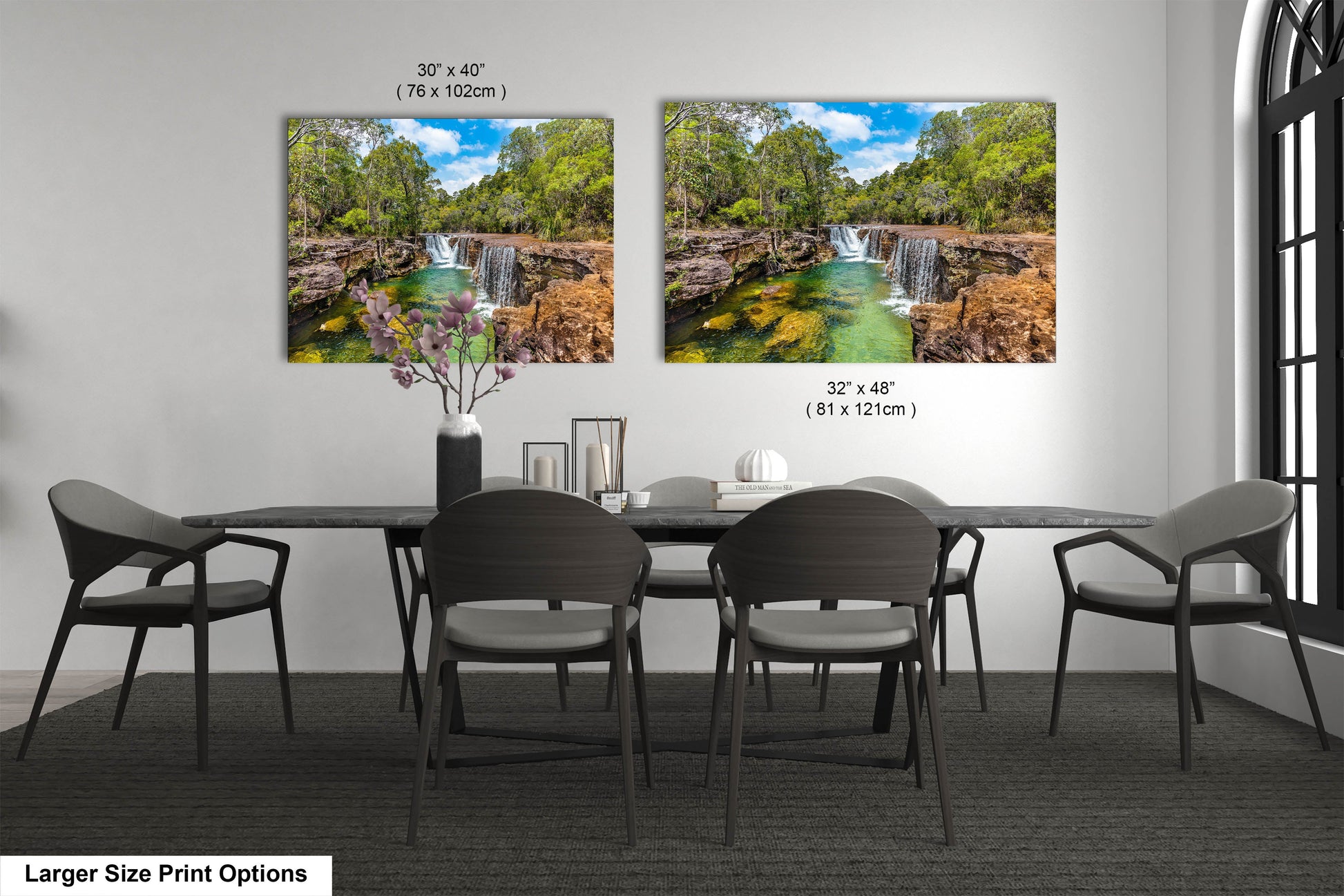 a dining room table with four chairs and a painting of a waterfall